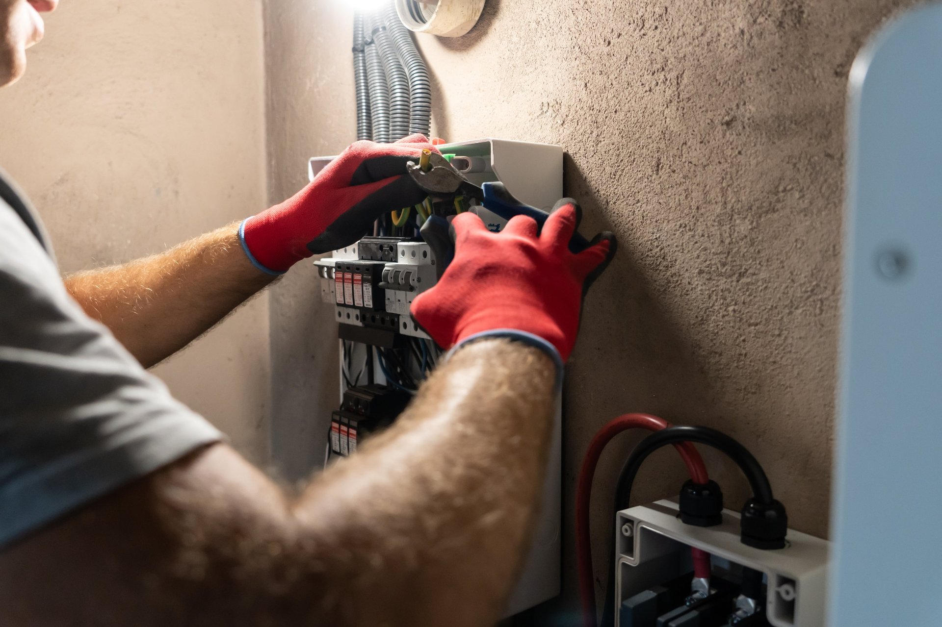 Electrician working on electrical panel